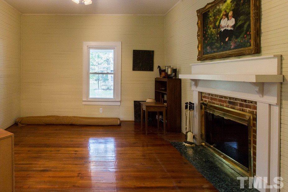 2730 Little River Church Road Hurdle Mills, NC 27541 - Photo 20 of 25 a living room with furniture and a fireplace