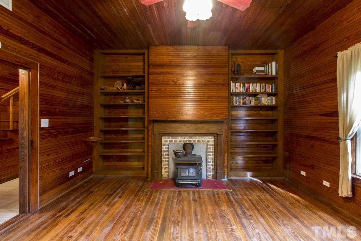 2730 Little River Church Road Hurdle Mills, NC 27541 - Photo 21 of 25 a view of an empty room with wooden floor and fire place