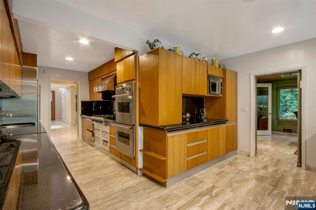 278 Fountain Road Englewood, NJ 07631 - Photo 13 of 37 a kitchen with stainless steel appliances a stove a refrigerator and a sink