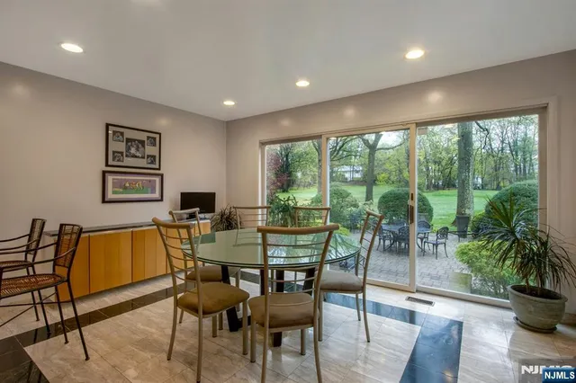 a dining room with furniture and wooden floor