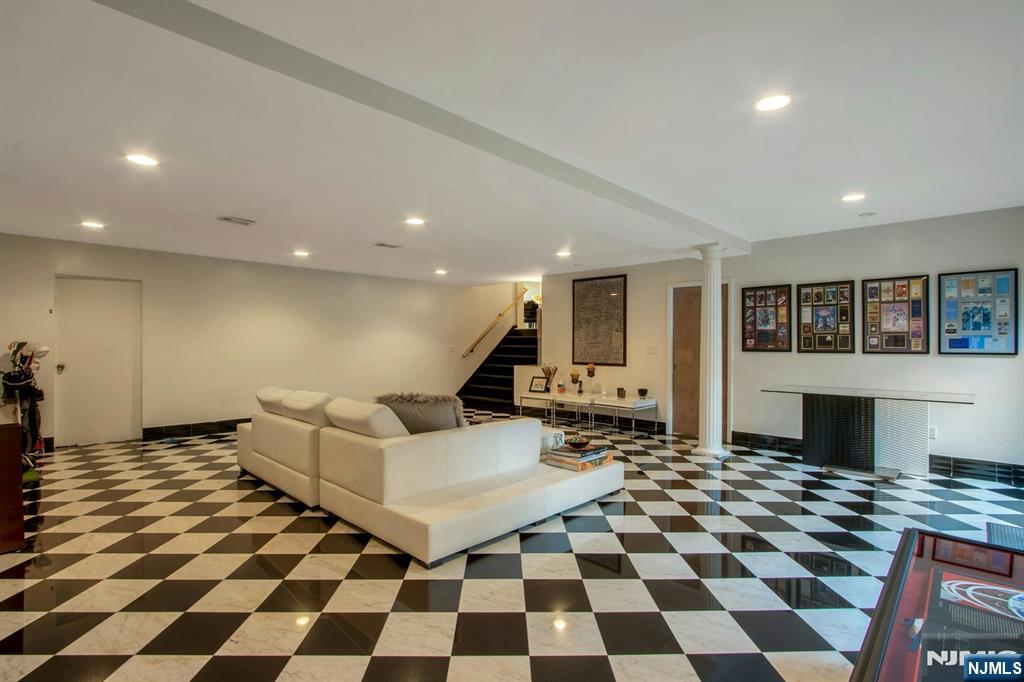 278 Fountain Road Englewood, NJ 07631 - Photo 17 of 37 a living room with a black white checkered floor with couches chair and a coffee table