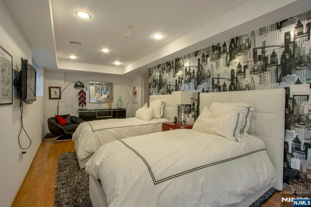 278 Fountain Road Englewood, NJ 07631 - Photo 20 of 37 a bed room with two bed and a large mirror