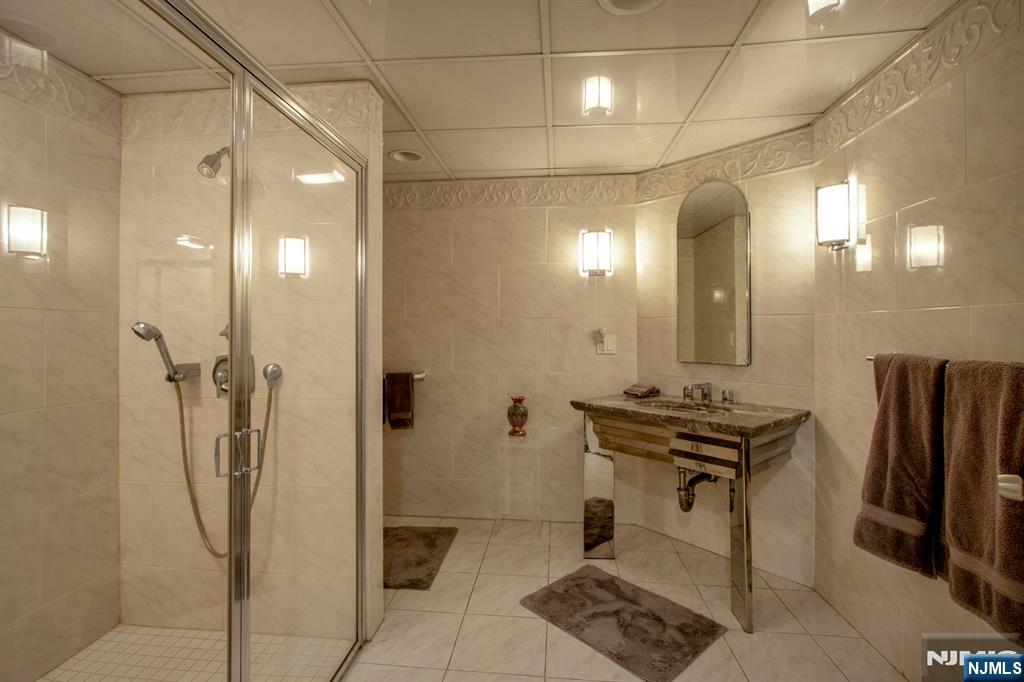 278 Fountain Road Englewood, NJ 07631 - Photo 21 of 37 a bathroom with a sink a toilet and shower