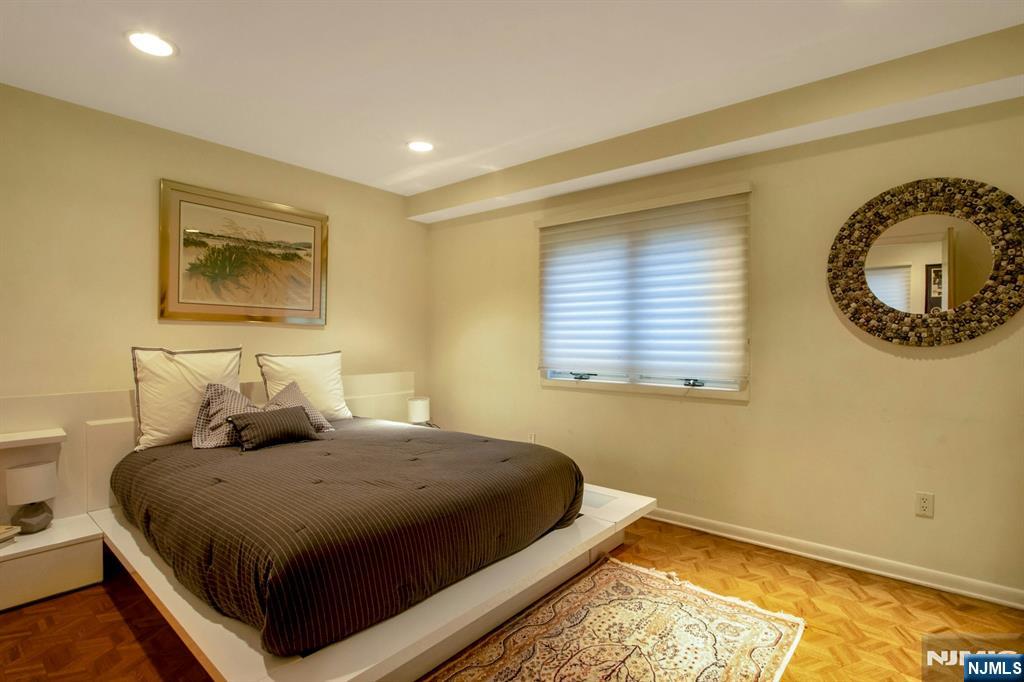 278 Fountain Road Englewood, NJ 07631 - Photo 24 of 37 a bedroom with a bed and a painting on the wall