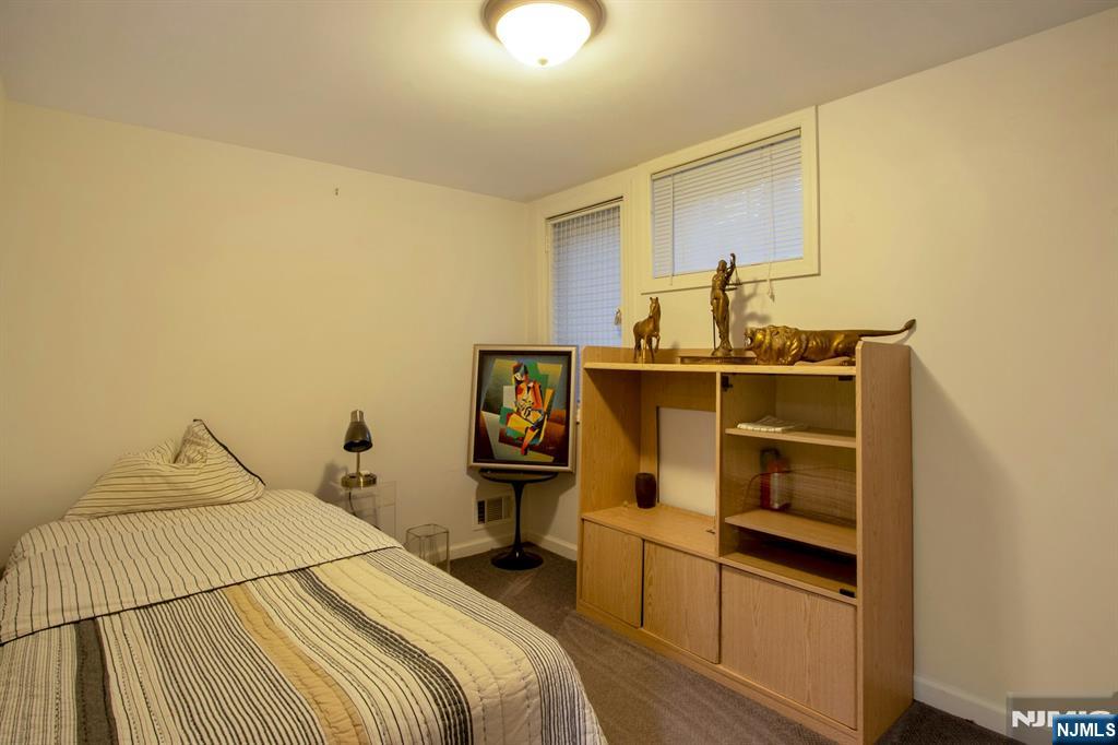 278 Fountain Road Englewood, NJ 07631 - Photo 25 of 37 a bedroom with a bed and cabinets