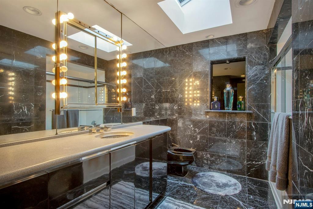 278 Fountain Road Englewood, NJ 07631 - Photo 26 of 37 a bathroom with a sink and a mirror