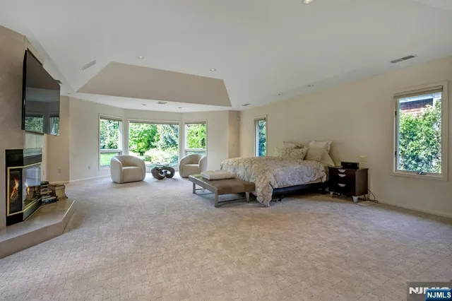 a spacious bathroom with a tub sink and mirror