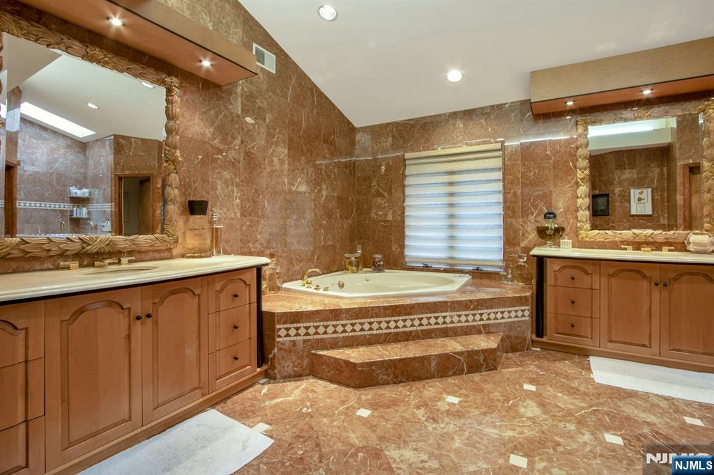 278 Fountain Road Englewood, NJ 07631 - Photo 32 of 37 a spacious bathroom with a tub sink and mirror