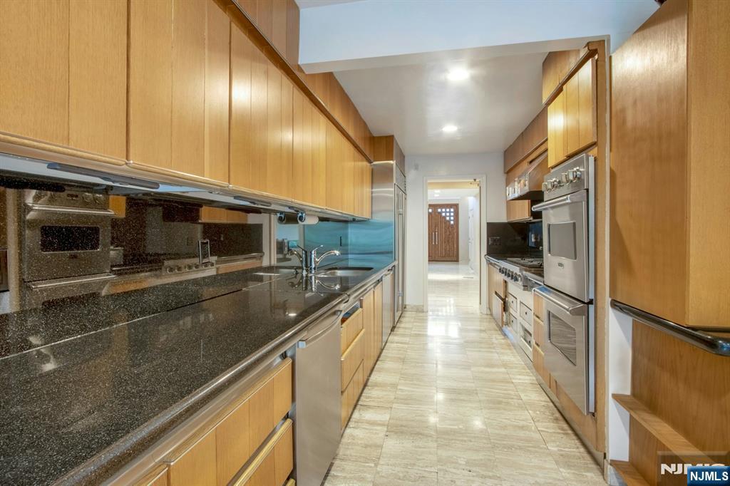 278 Fountain Road Englewood, NJ 07631 - Photo 8 of 37 a large kitchen with lots of counter space and stainless steel appliances