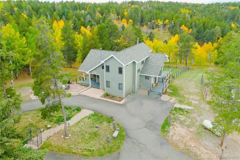 an aerial view of a house with a yard basket ball court and outdoor seating
