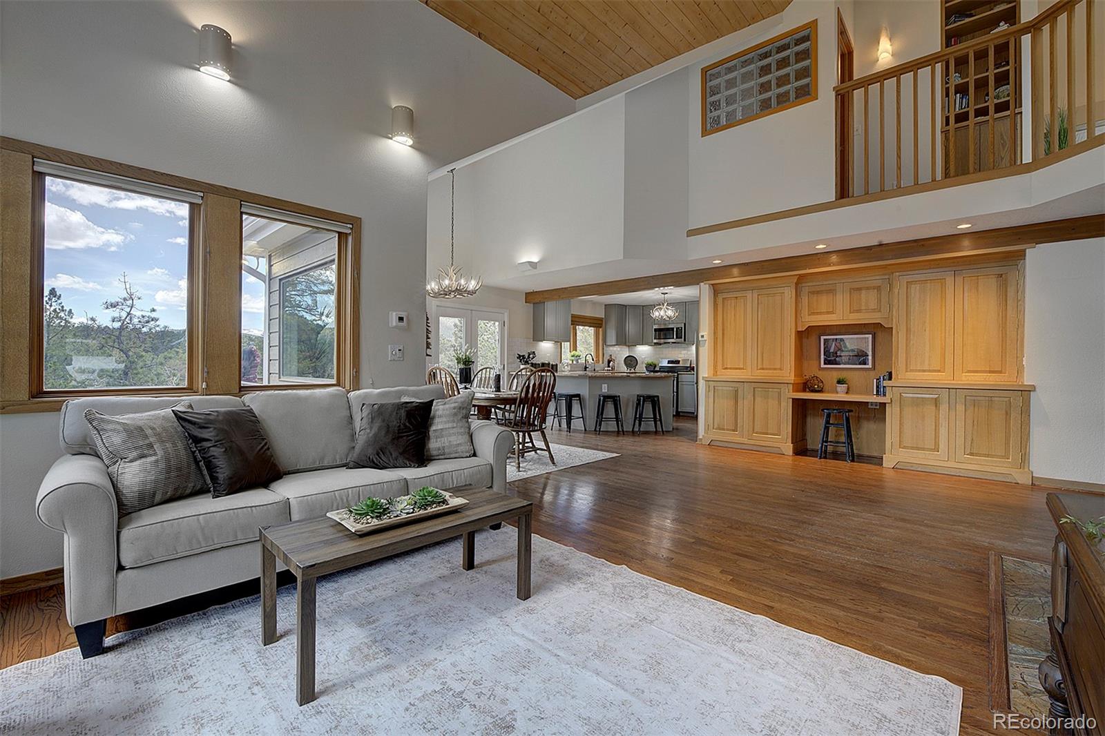 27987 Richmond Hill Road Conifer, CO 80433 - Photo 13 of 46 a living room with furniture and a large window
