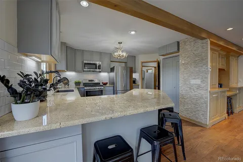 a kitchen with a sink and large window
