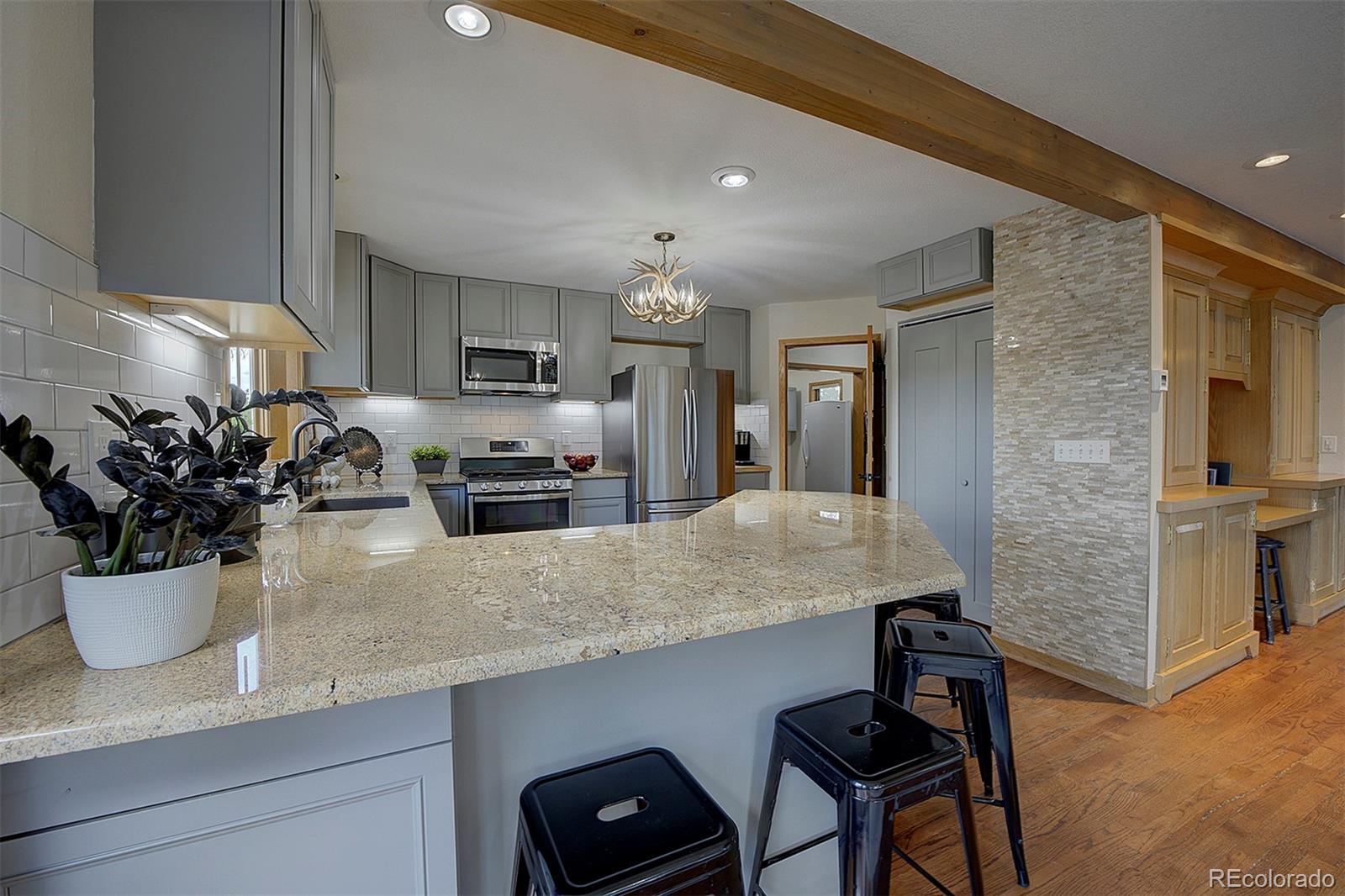 27987 Richmond Hill Road Conifer, CO 80433 - Photo 16 of 46 a kitchen with a table and chairs in it