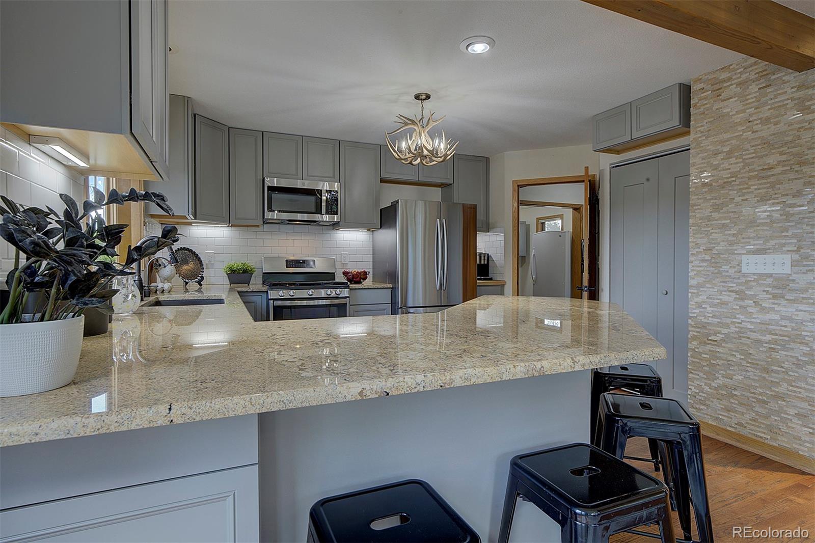 27987 Richmond Hill Road Conifer, CO 80433 - Photo 18 of 46 a kitchen with stainless steel appliances a sink and a refrigerator