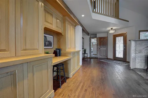 a balcony with wooden floor and fence