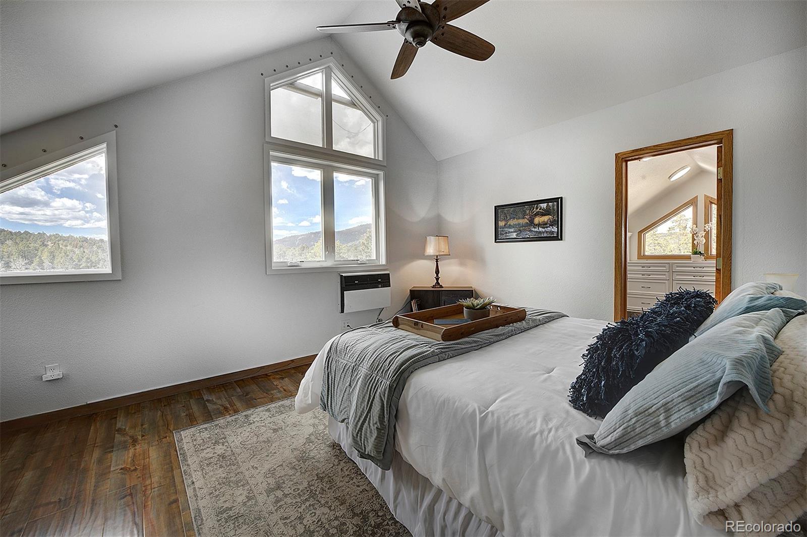 27987 Richmond Hill Road Conifer, CO 80433 - Photo 32 of 46 a bedroom with bed and window