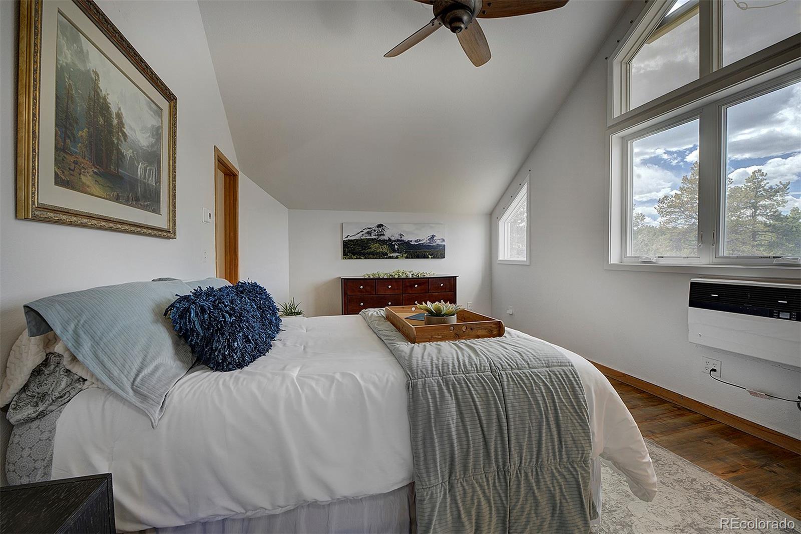 27987 Richmond Hill Road Conifer, CO 80433 - Photo 33 of 46 a bedroom with a bed and window