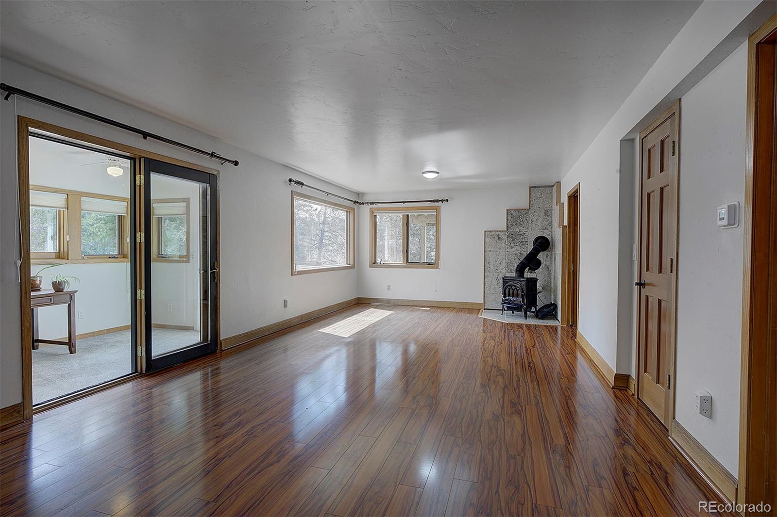 27987 Richmond Hill Road Conifer, CO 80433 - Photo 38 of 46 a view of a livingroom with wooden floor and furniture