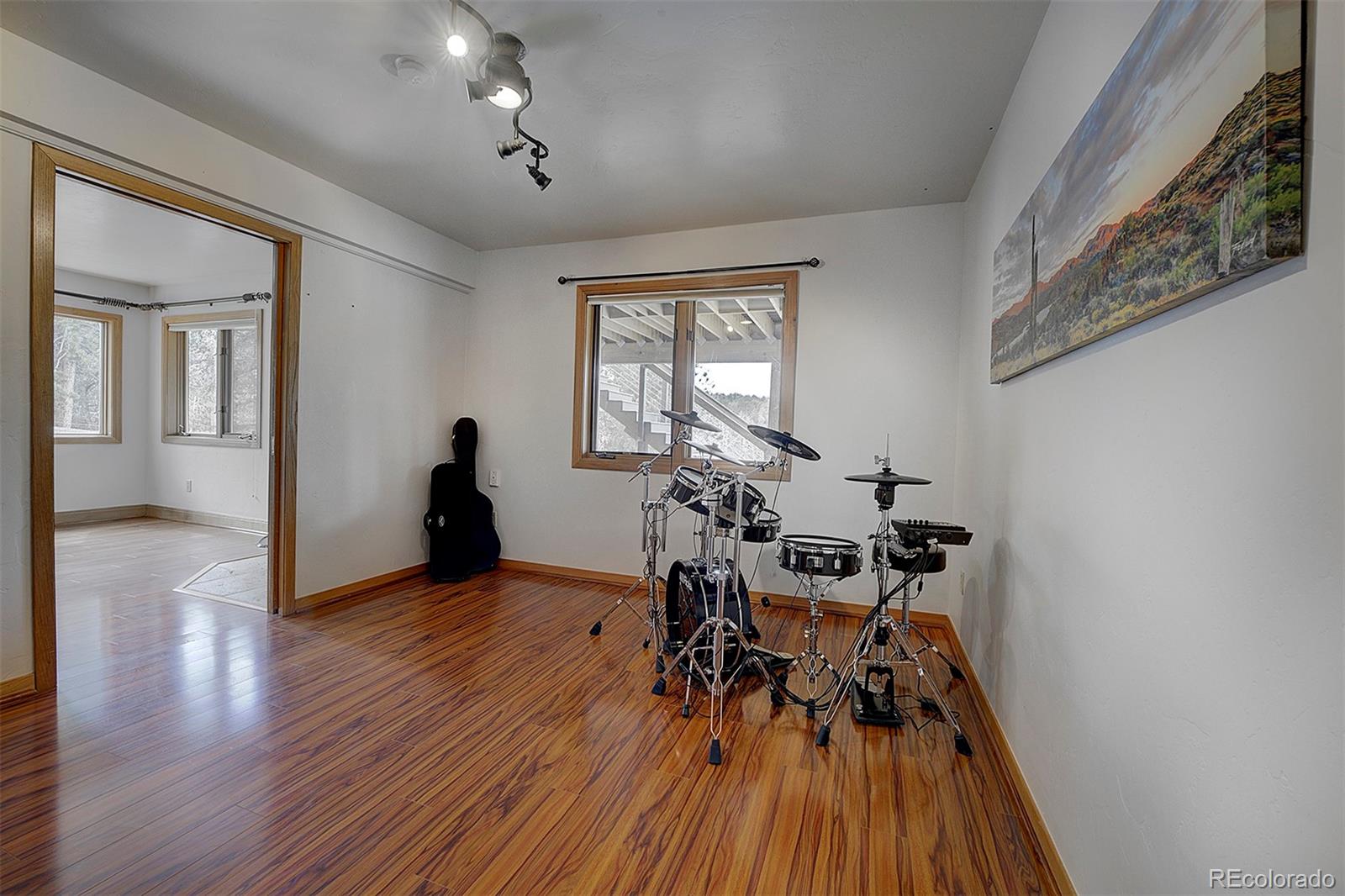 27987 Richmond Hill Road Conifer, CO 80433 - Photo 41 of 46 a view of a room with wooden floor furniture and a window