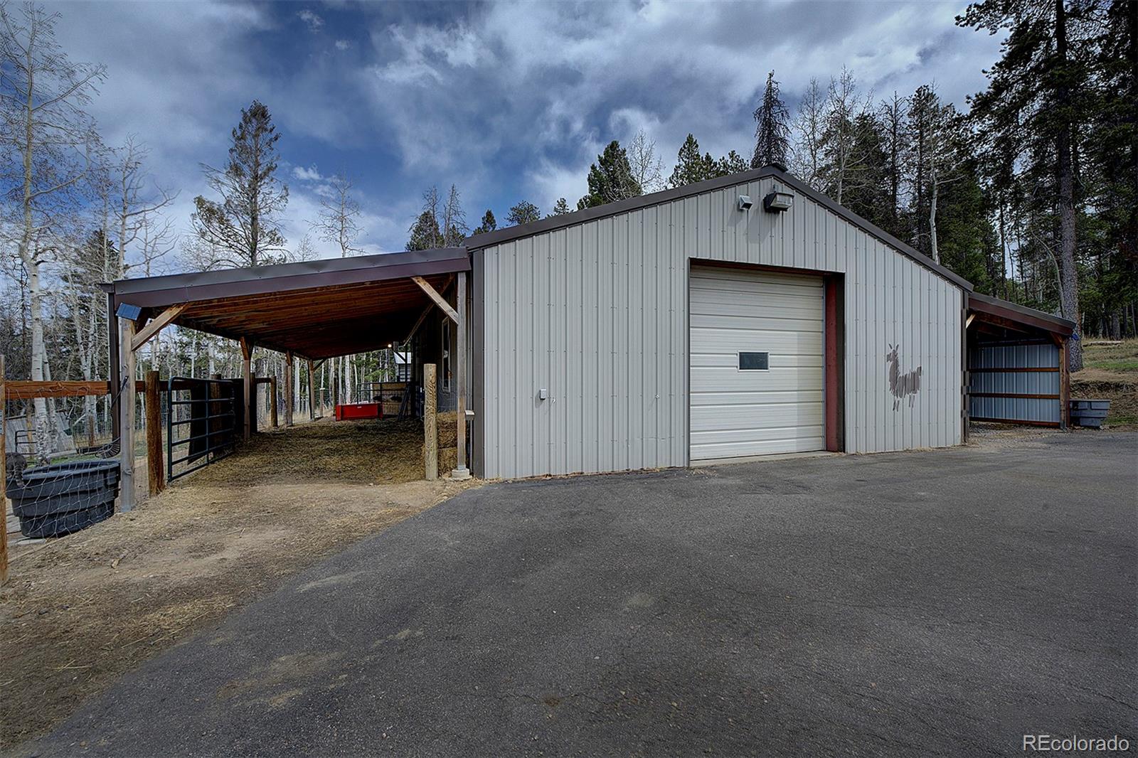 27987 Richmond Hill Road Conifer, CO 80433 - Photo 46 of 46 a view of a wooden house with a outdoor space