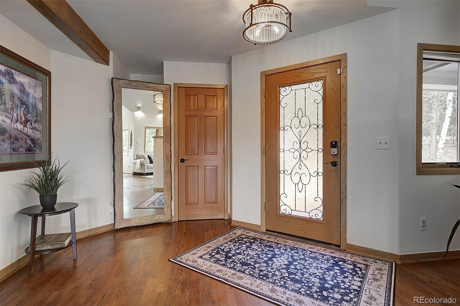 27987 Richmond Hill Road Conifer, CO 80433 - Photo 9 of 46 a view of an entryway with wooden floor