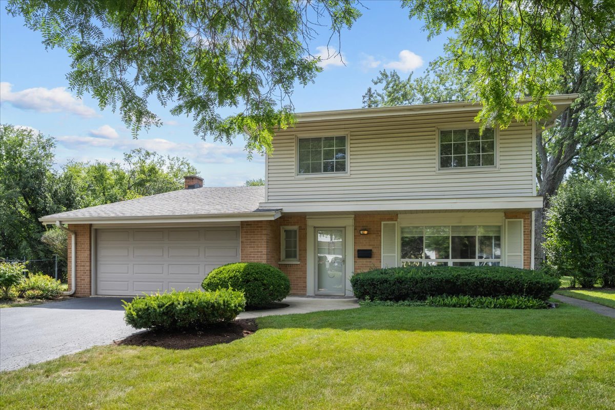 49 Larkdale E Road Deerfield, IL 60015 - Photo 1 of 24 a front view of a house with a yard and garage