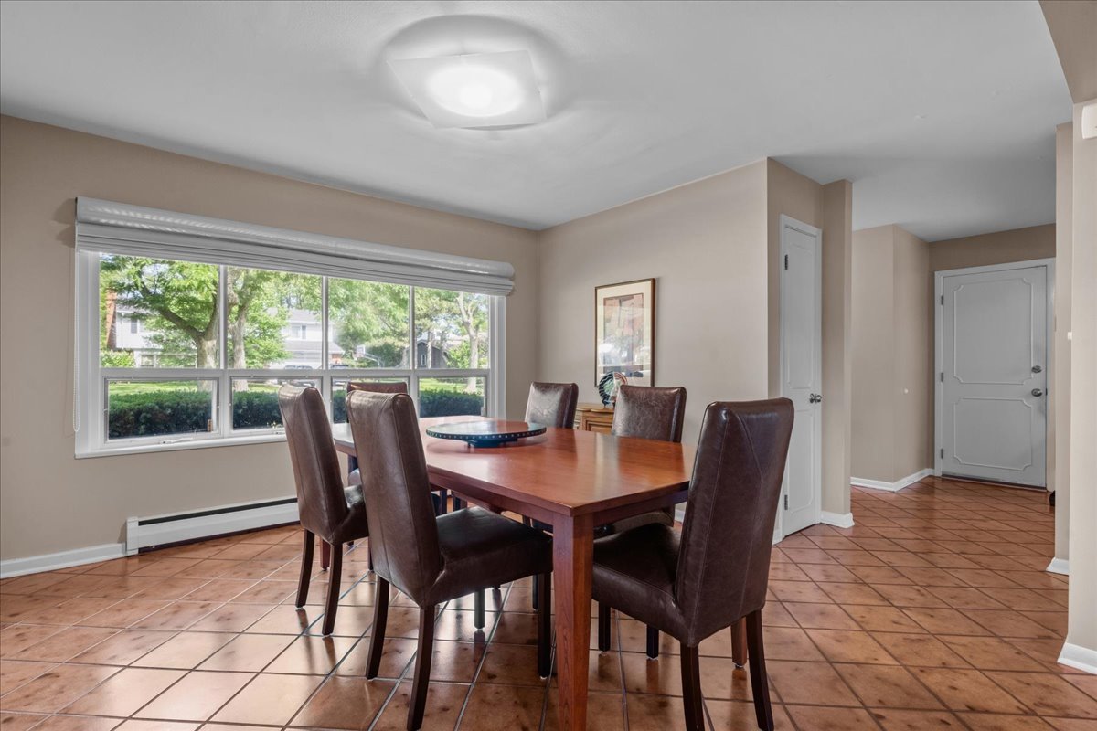 49 Larkdale E Road Deerfield, IL 60015 - Photo 4 of 24 a view of a dining room with furniture and a window
