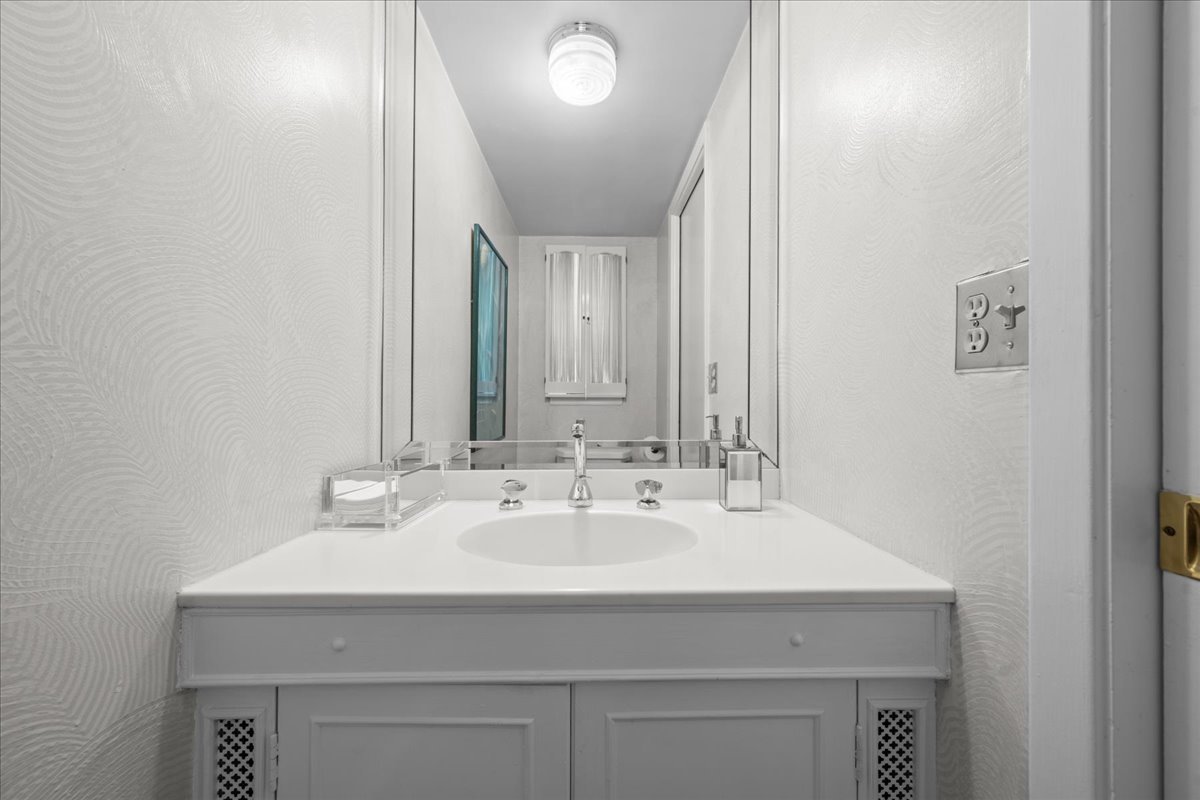 49 Larkdale E Road Deerfield, IL 60015 - Photo 9 of 24 a bathroom with a sink and a mirror