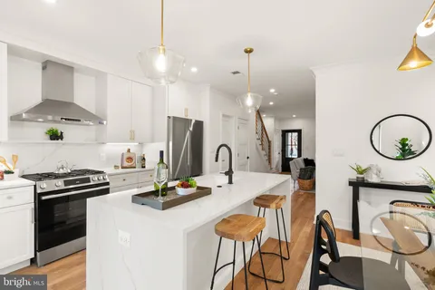 a view of a dining room with furniture and a chandelier