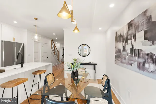 a very nice looking kitchen with furniture and a chandelier