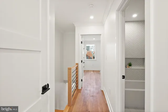 a view of a hallway with wooden floor