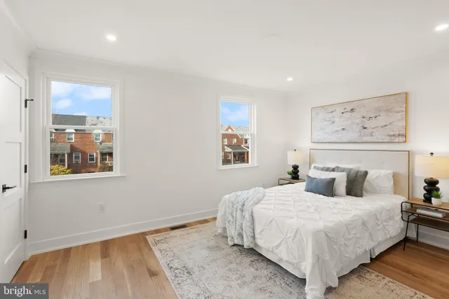 a bedroom with a bed and a potted plant