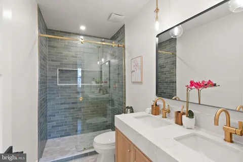 a bedroom with a large bed and a potted plant