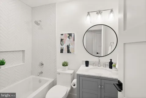 a living room with furniture a rug and a wall painting