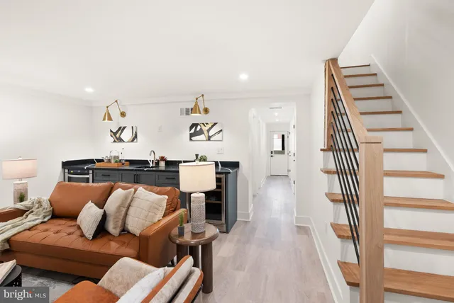 a living room with furniture and a potted plant