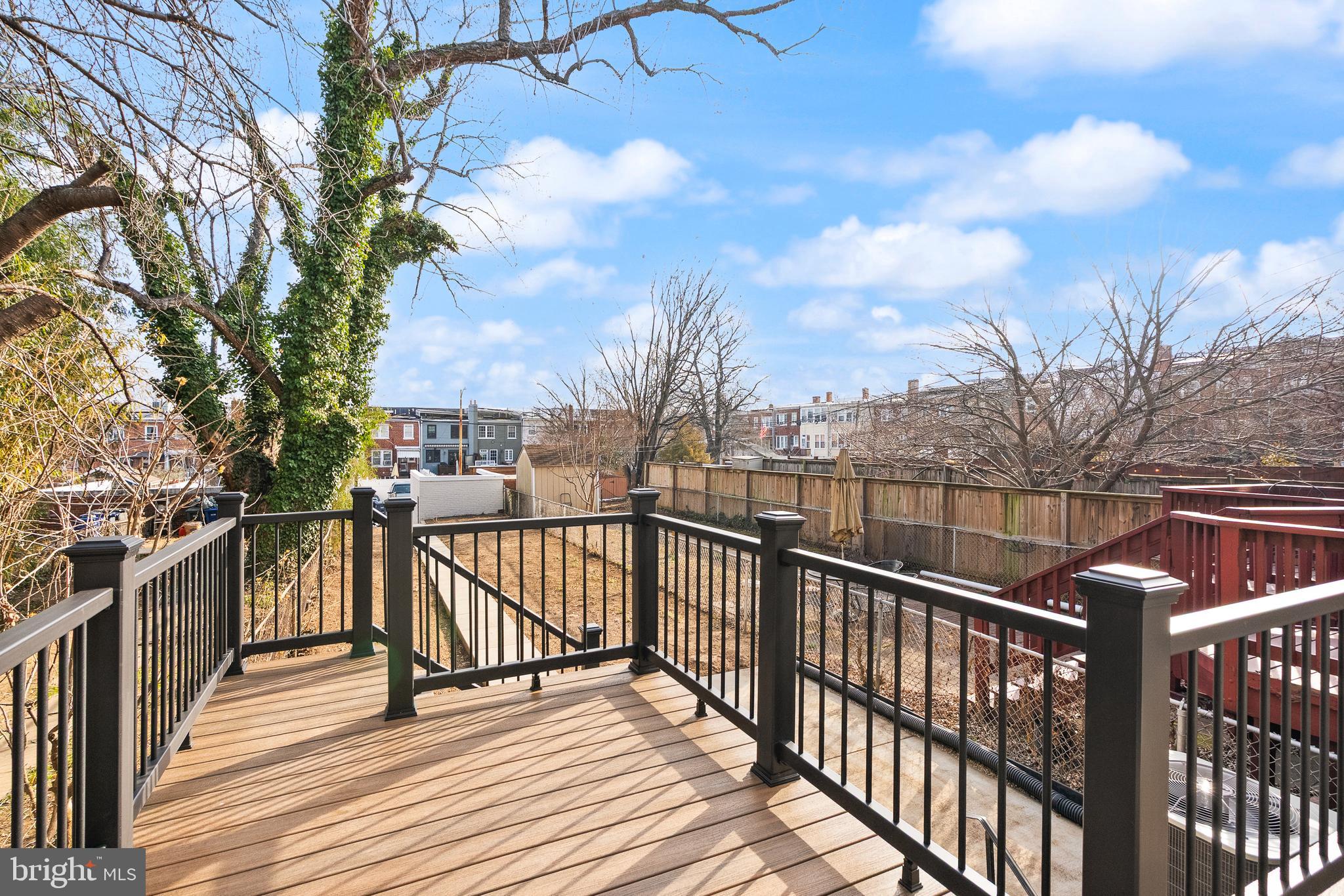 321 16th Street Northeast Washington, DC 20002 - Photo 4 of 9 a view of a balcony with wooden floor and fence