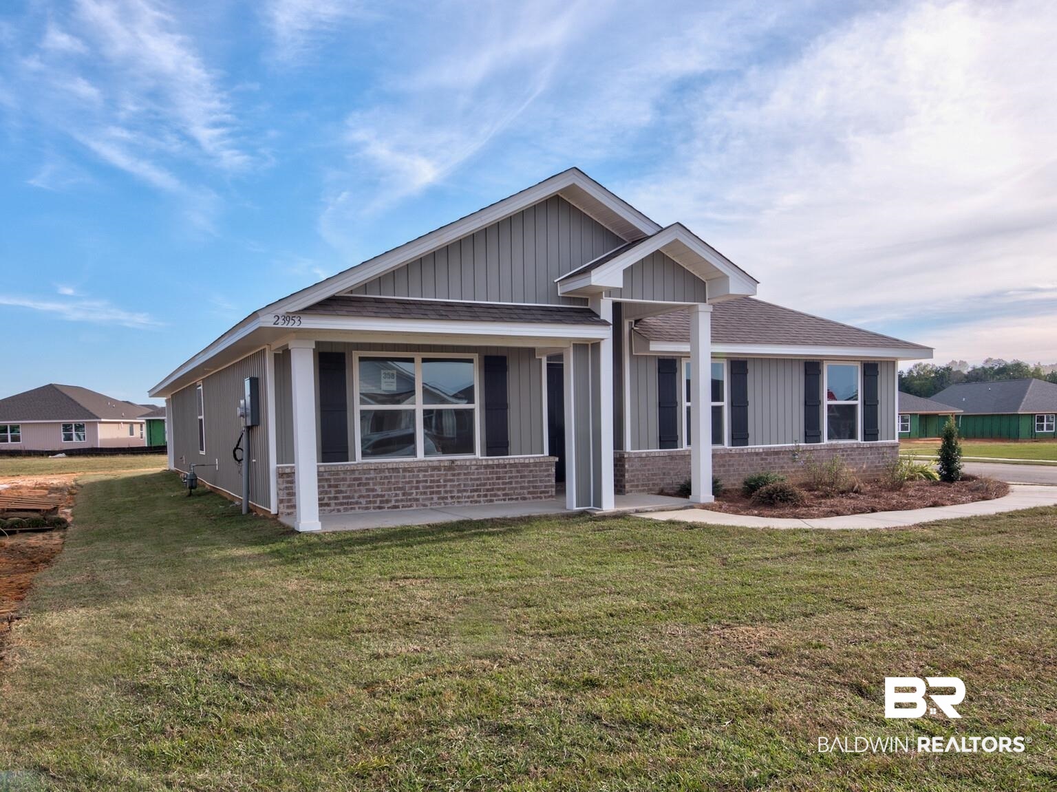 23953 Citation Loop Daphne, AL 36526 - Photo 2 of 49 View of front facade featuring brick siding, a front lawn, a shingled roof, and board and batten siding