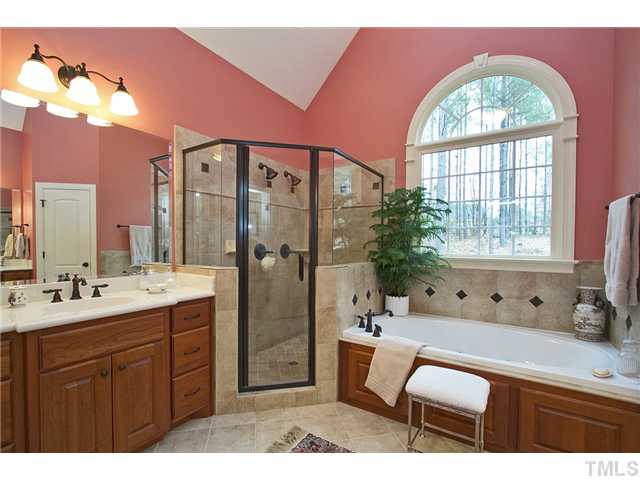 1004 Widgeon Way Raleigh, NC 27603 - Photo 19 of 25 Dramatic master bathroom has split sinks, lots of pretty tile and a large whirlpool tub.