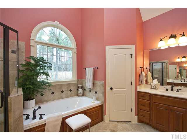 1004 Widgeon Way Raleigh, NC 27603 - Photo 20 of 25 Master bath has its own linen closet. Large shower boasts dual shower heads and faucets.
