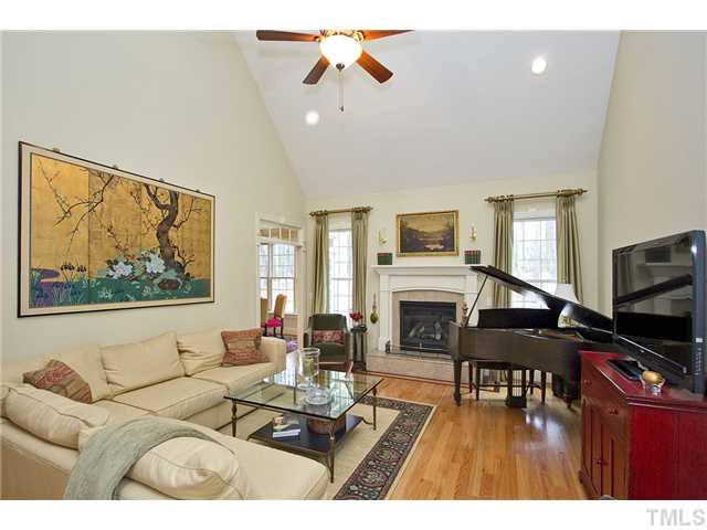 Vaulted and dramatic living room with gas log fireplace.