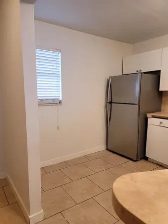 a white refrigerator freezer sitting in a kitchen