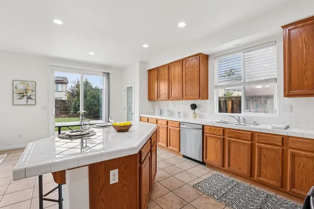 a kitchen with granite countertop sink stove and cabinets