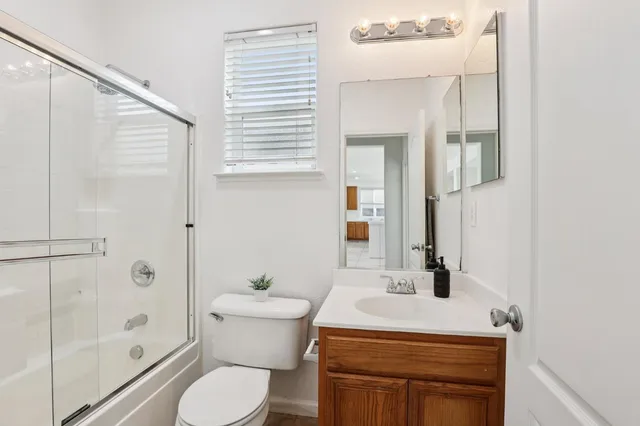 a bathroom with a sink toilet and shower
