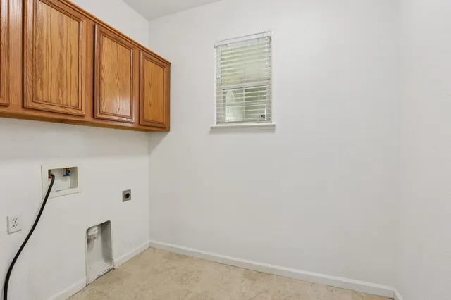 a view of storage and utility room with a window