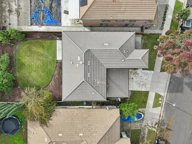an aerial view of a house with a yard and potted plants