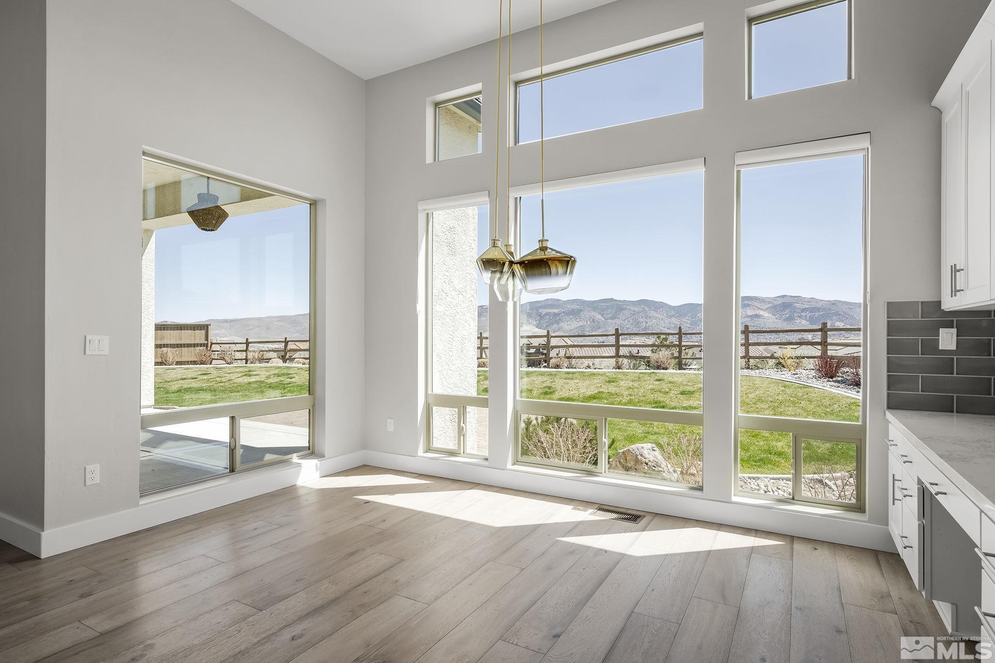 13326 Travertine Lane Reno, NV 89511 - Photo 11 of 36 a view of an empty room with wooden floor and a window