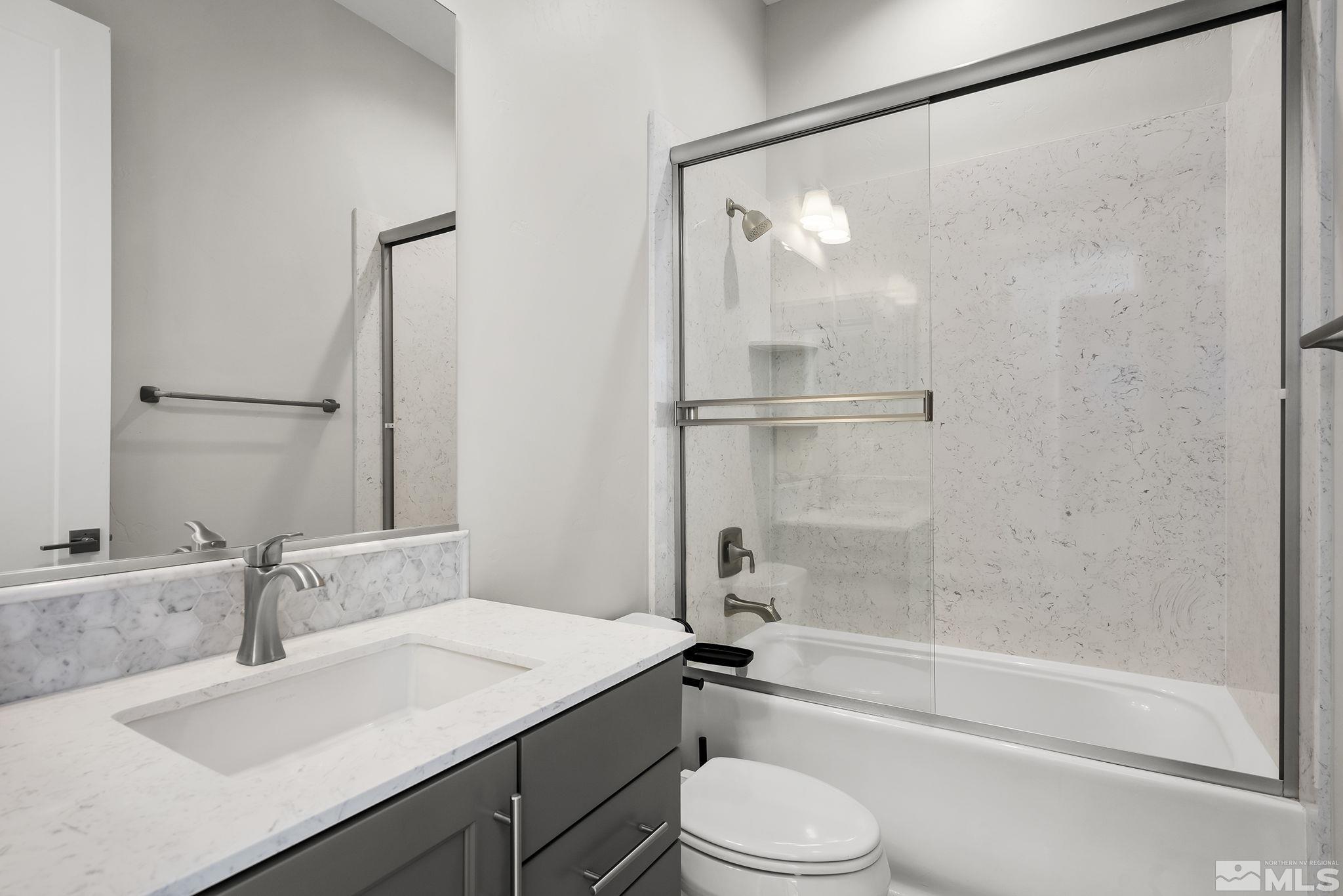 13326 Travertine Lane Reno, NV 89511 - Photo 20 of 36 a bathroom with a granite countertop sink toilet and shower