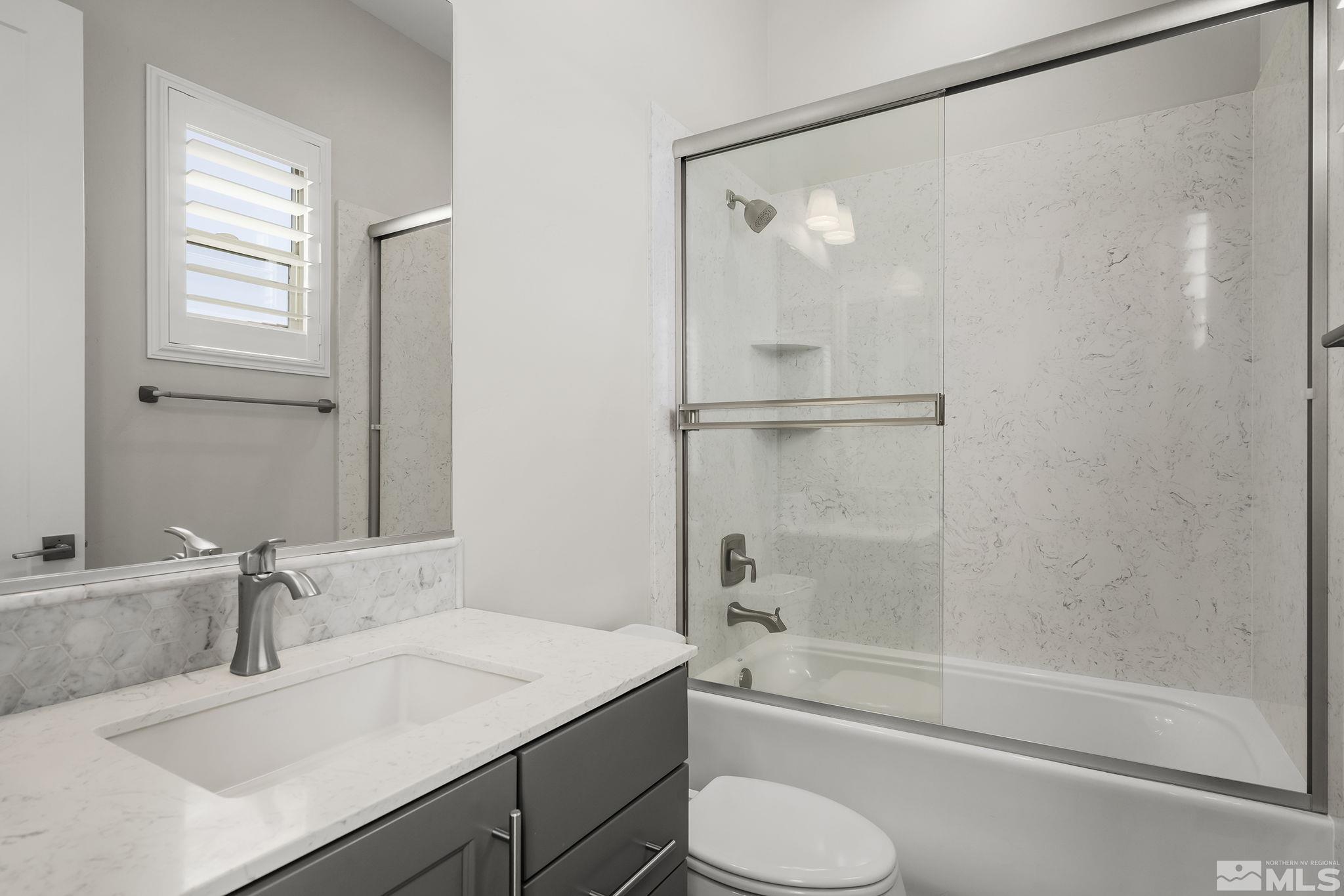 13326 Travertine Lane Reno, NV 89511 - Photo 24 of 36 a bathroom with a granite countertop sink toilet and shower