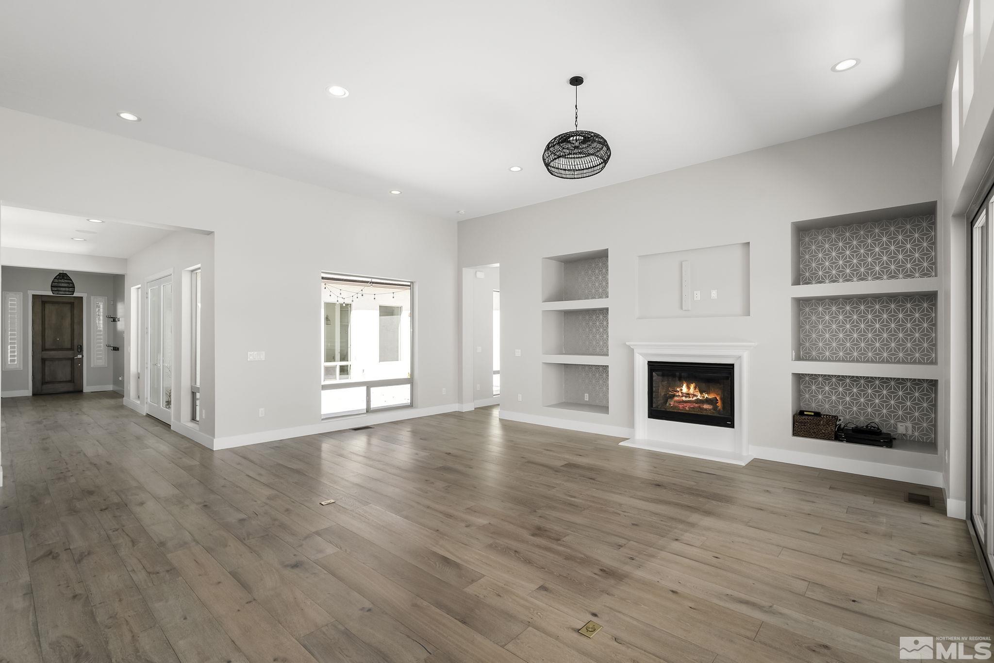13326 Travertine Lane Reno, NV 89511 - Photo 7 of 36 a view of an empty room with a window and fireplace