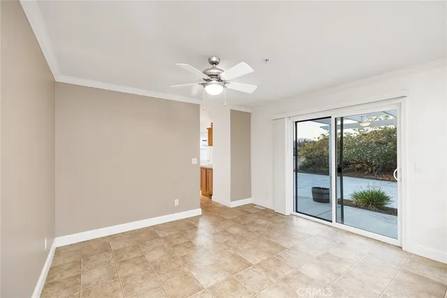 a view of a big room with windows and chandelier fan
